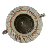 top view of hand-painted stoneware vase with twin handles and a reactive glaze of cream, green, and brown on a white background