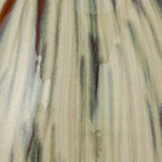 close up view of the reactive glaze of green, brown, and cream on the Miles Vase
