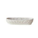 White oval bread proofing basket with a cover on a white background