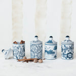 Set of four blue and white ceramic canisters with decorative patterns on a white background
