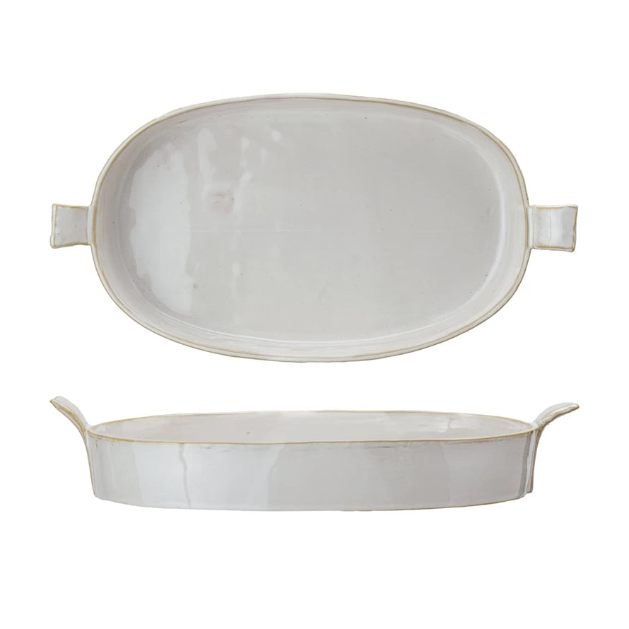 Two oval ceramic dishes with handles on a white background