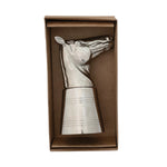 Metallic horse-shaped jigger in a brown box on a white background