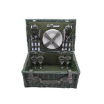 Green picnic basket with cutlery and plates on a white background