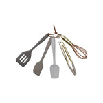 Set of kitchen utensils including a spatula, ladle, and whisk on a white background