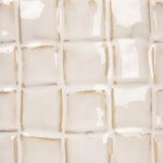 Close-up of a textured beige tile pattern