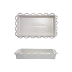 White ceramic napkin holder with decorative scalloped edge on a white background