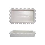 White ceramic napkin holder with decorative scalloped edge on a white background