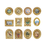 Collection of gold-framed art magnets with various scenes on a white background