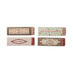 Four matchboxes with decorative labels on a white background