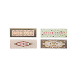 Four matchboxes with decorative labels on a white background