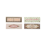 Four matchboxes with decorative labels on a white background
