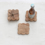 styled set of four mango wood coasters tied together with a jute rope