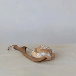 Wooden bread knife with a loaf of bread on a light surface