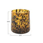 Tortoiseshell patterned drinking glass with dimensions on a white background