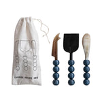 Set of cheese knives with blue bead handles and a branded drawstring bag on a white background