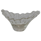 Clear glass bowl with wavy edge on a white background