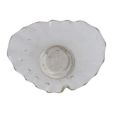 White ceramic plate with scalloped edge on a white background