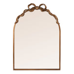 An arched wall mirror with an ornate bronze bow detail at the top, set against a plain white background.