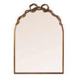 An arched wall mirror with an ornate bronze bow detail at the top, set against a plain white background.