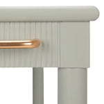 Close-up of a light gray cabinet with a gold handle on a white background