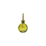 Green glass bottle with brass cap on a white background