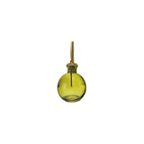 Green glass bottle with brass cap on a white background