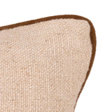 Close-up of a woven beige cushion with a contrasting brown piped edge on a white background.