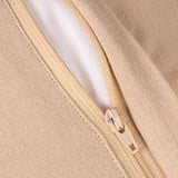 Close-up of a beige knit fabric garment with a matching beige zipper and a white inner lining.