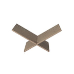 Metallic X-shaped object on a white background