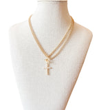  Necklace blends elegance with modern edge, featuring a double-layered gold chain and a sleek toggle clasp. A white pearl cross charm 