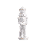 White ceramic nutcracker figurine on a white background