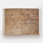 Open book with wooden texture pages displaying 'Fish and Seafood' text on a white background
