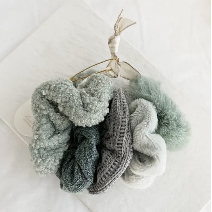 Set of sage and white scrunchies on a white background