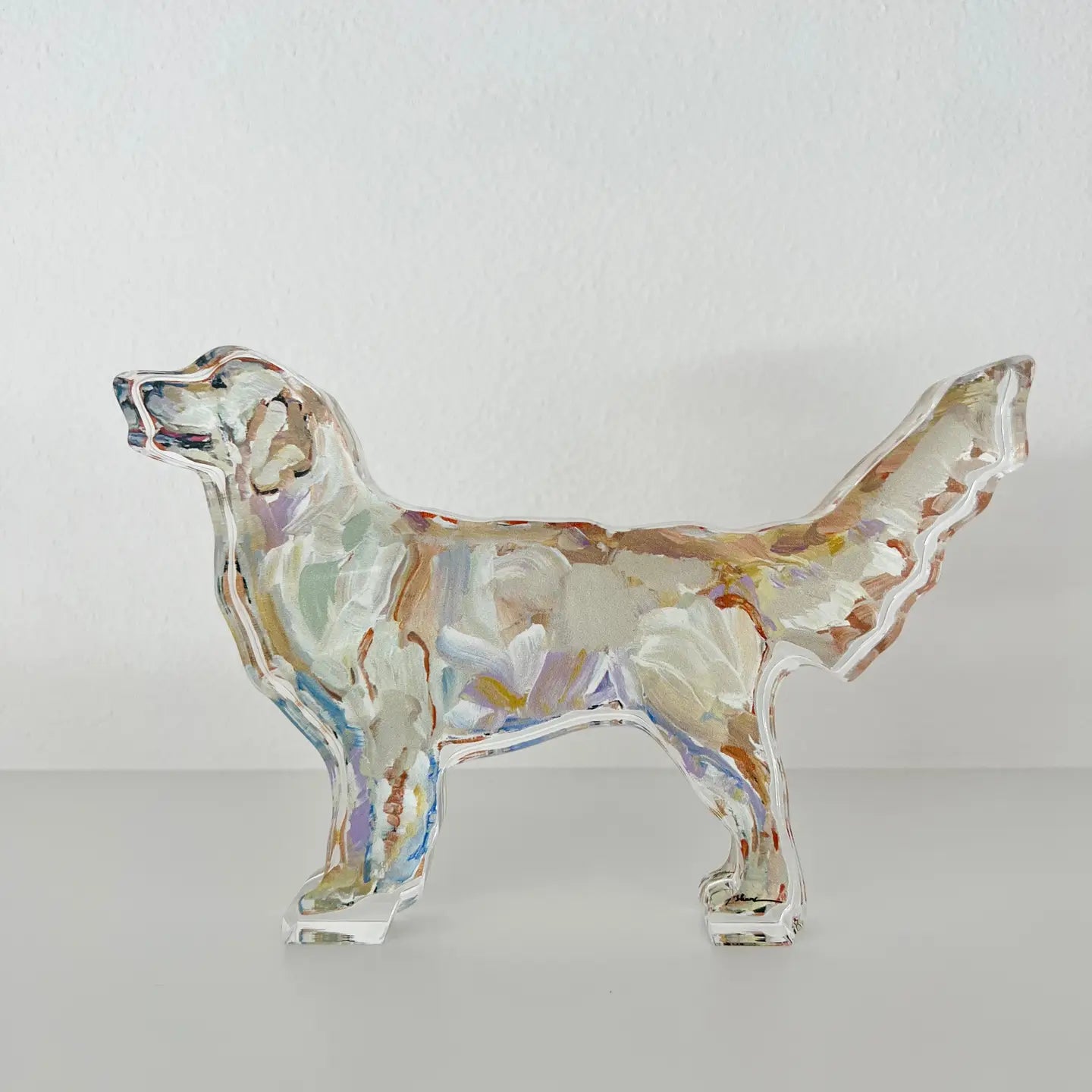Glass dog figurine with multicolored pattern on a white background