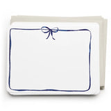 White card with blue border and bow on a white background