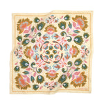 Decorative bandana with floral and paisley pattern on a beige background