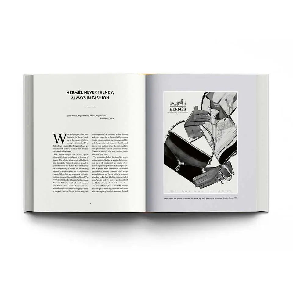 Open book with Hermès advertisement on a white background