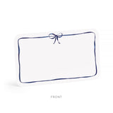 White pillow with a blue border and bow on a white background