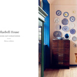 Dining room with blue walls, wooden furniture, and decorative plates on the wall.