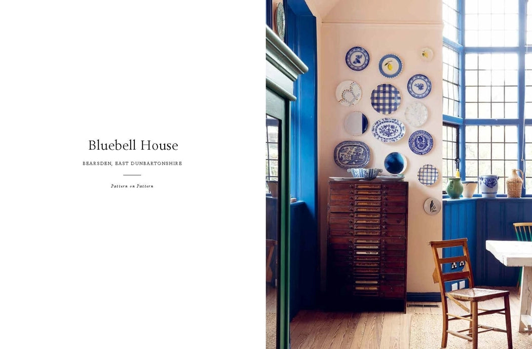 Dining room with blue walls, wooden furniture, and decorative plates on the wall.