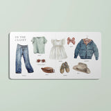 Illustrated children's book open to a page titled 'In the Closet' with clothing items on a light green background.