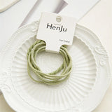 Green hair bands on a white plate with HenJu label