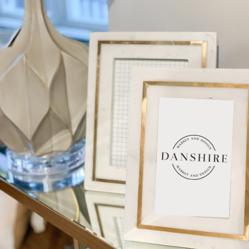 styled white marble frame, brass inlay