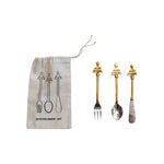 Set of gold and silver cutlery with a branded drawstring bag on a white background