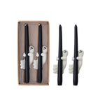 Set of black candles with ghost decorations in packaging on a white background