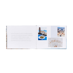 Open book showing a spread with images of food and a restaurant name on a white background