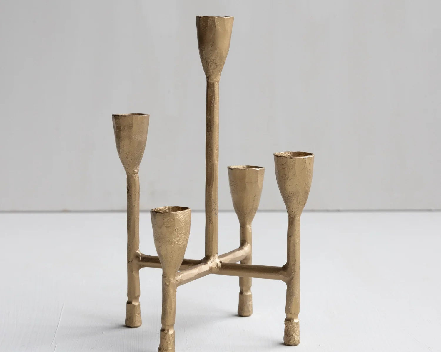 Brass candelabra with five candle holders on a white background