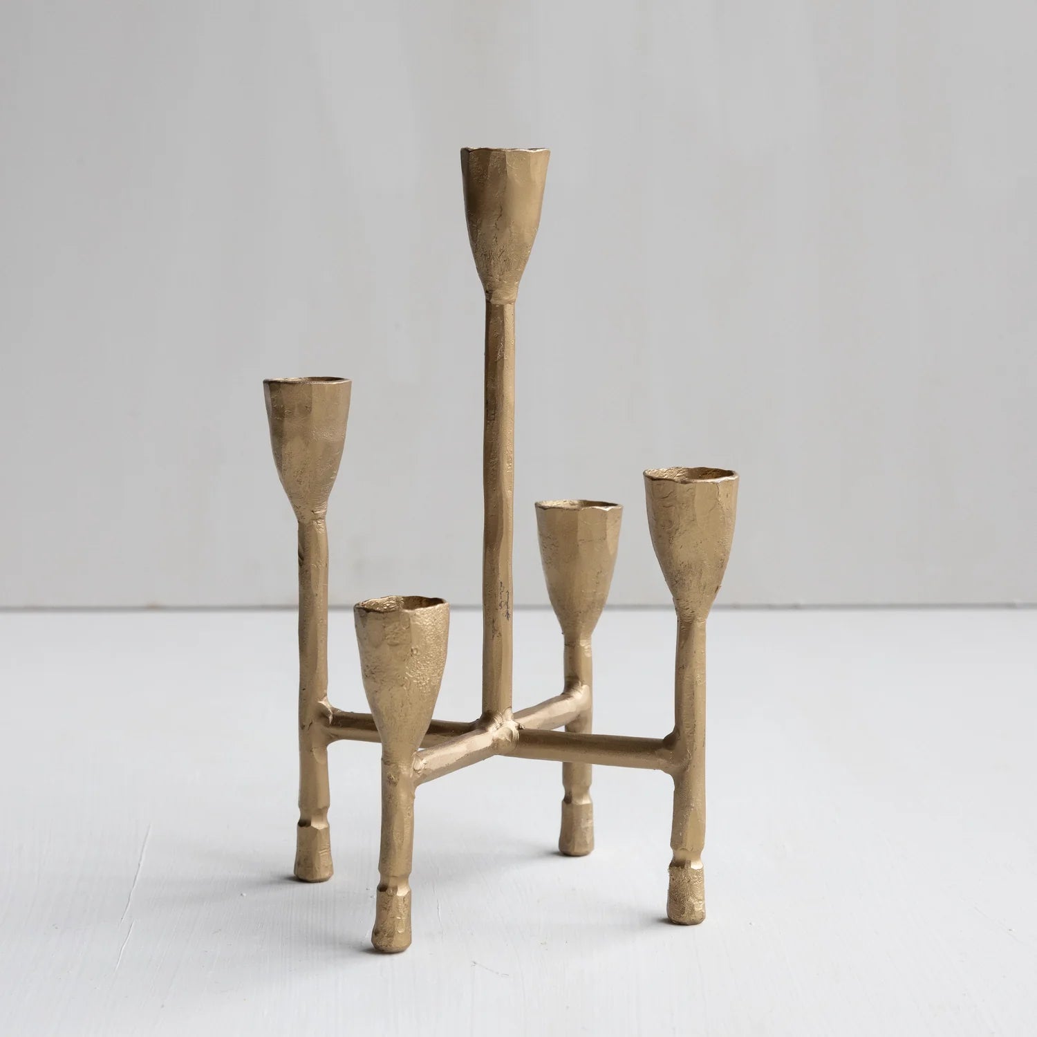 Brass candelabra with five candle holders on a white background