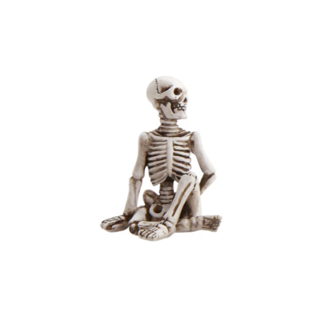 Skeletal figure in a meditative pose on a white background