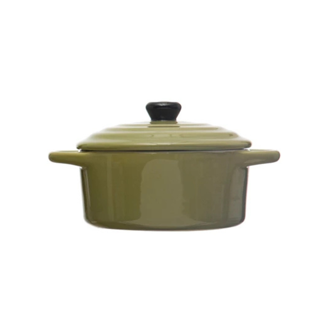 Green ceramic cooking pot with lid on a white background